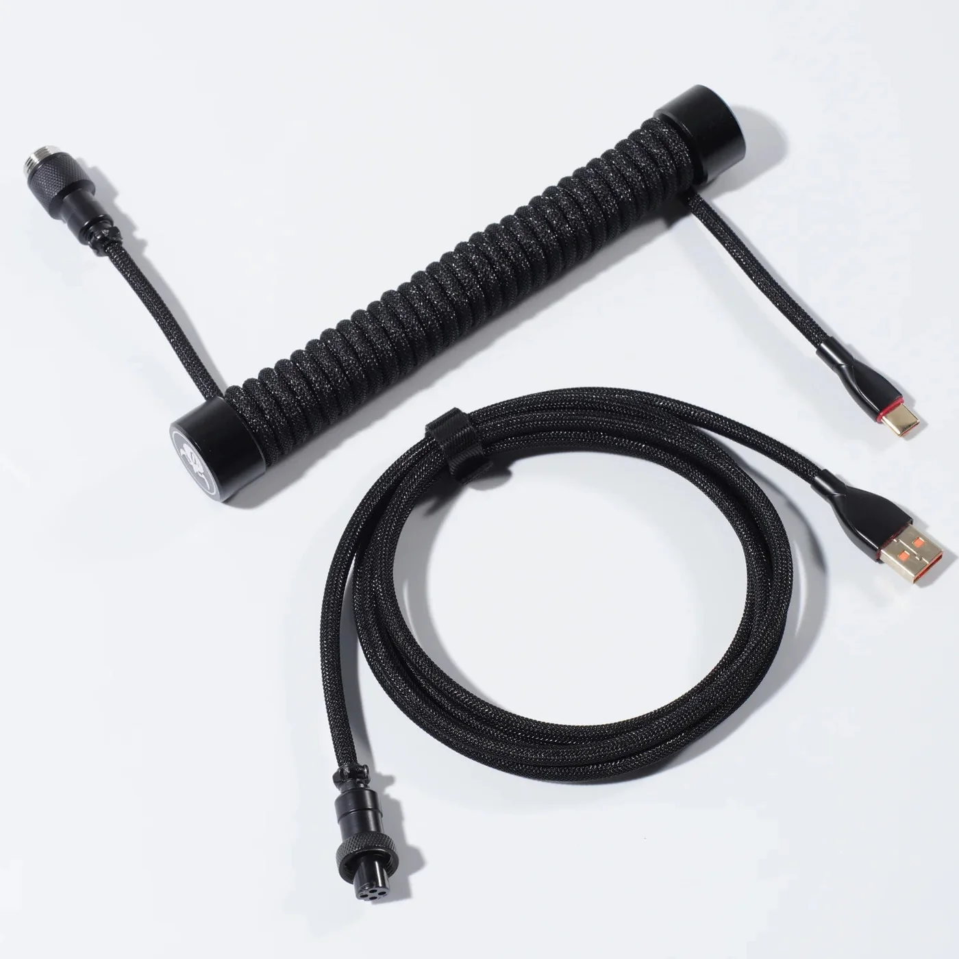 GravaStar Coiled Aviator USB cable in Black, showing the braided TPU core and EVA sleeve